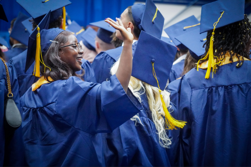 Spring Commencement Graduates with a focus on one grad