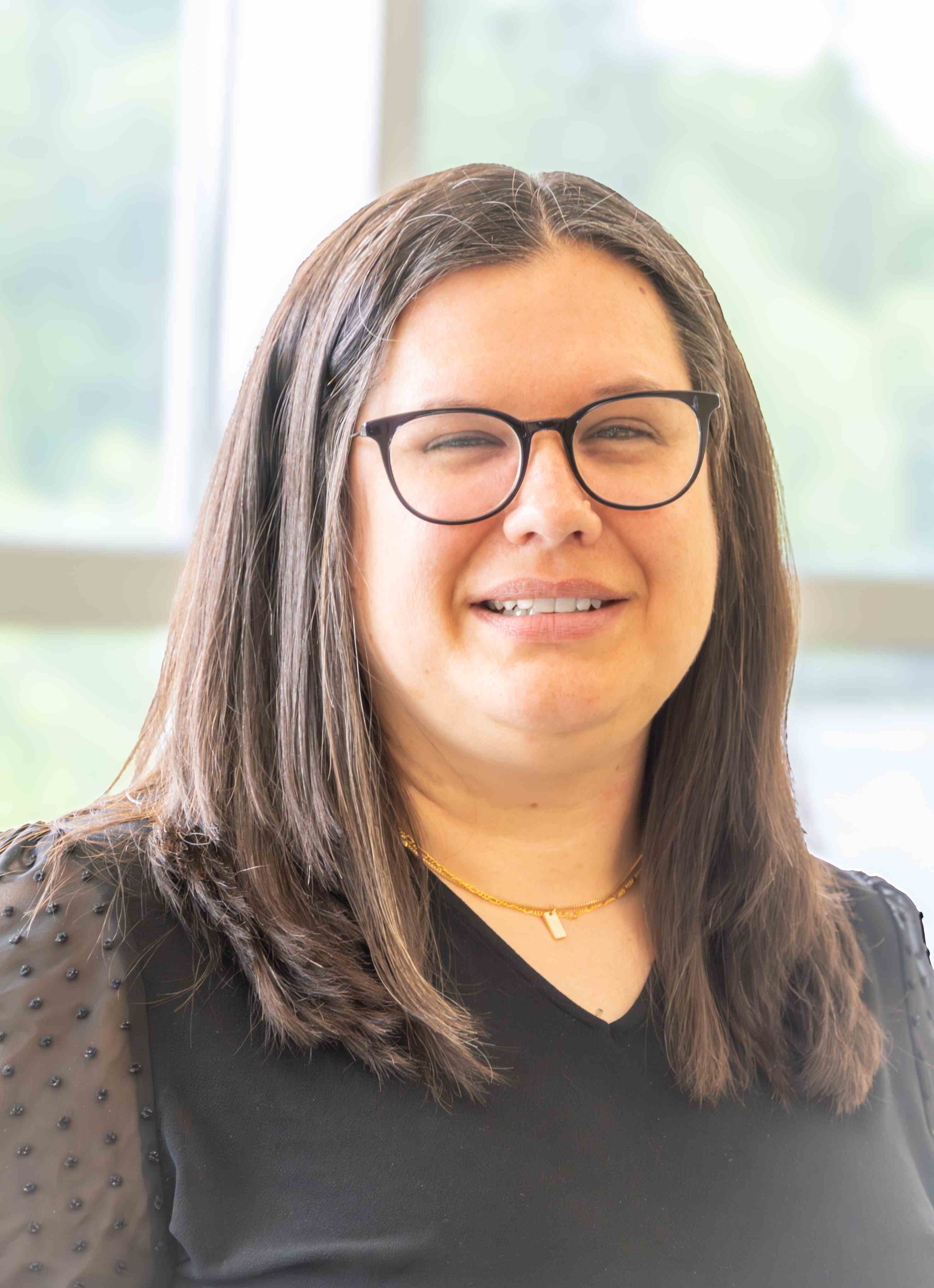 Headshot of Audrey Case who wears glasses and has straight brown hair