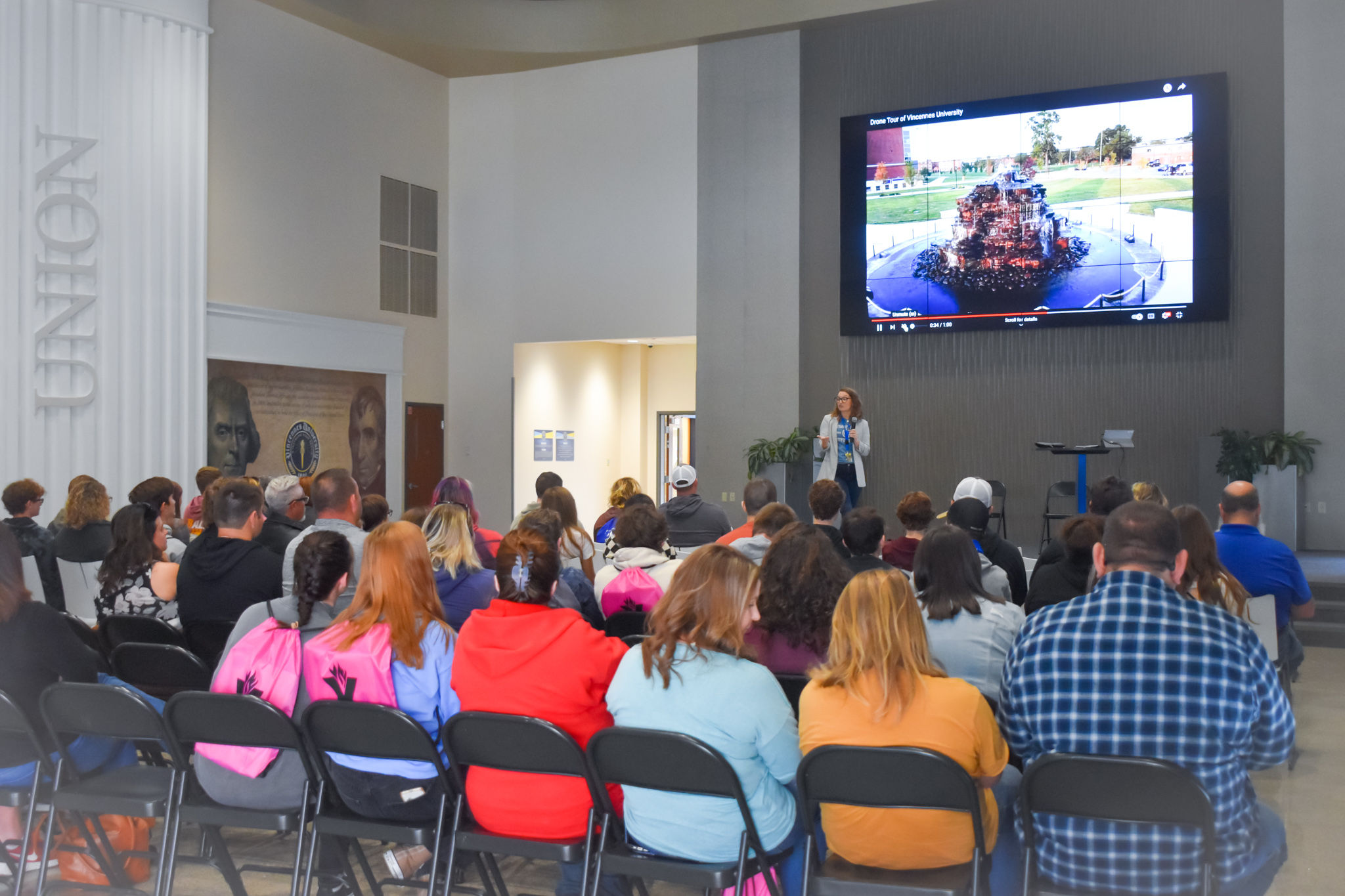 Sarah McLin stands on stage at Jefferson Student Union, in front of prospective students and families.