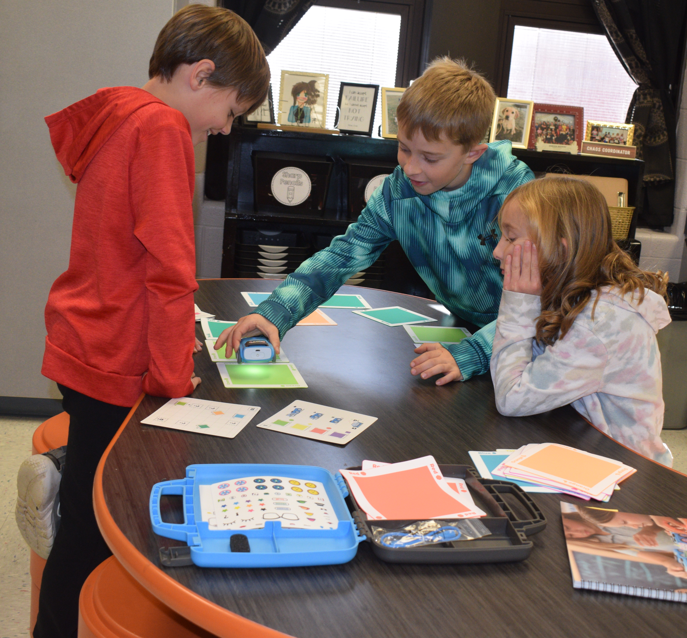 2 male and 1 female student interacting with a Sphero indi Robot in a South Knox School classroom.